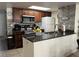 Well-appointed kitchen with a breakfast bar, granite countertops, stainless steel appliances, and a tile backsplash at 2494 Sweetwater Club Cir # 55, Kissimmee, FL 34746