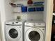 Bright laundry room featuring new Samsung washer and dryer and shelving space at 2494 Sweetwater Club Cir # 55, Kissimmee, FL 34746