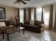 Cozy living room with two couches, decorative pillows, marble coffee table, and plenty of natural light at 2494 Sweetwater Club Cir # 55, Kissimmee, FL 34746