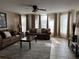 Comfortable living room with plush sofas, tile floors, decorative art, and large windows with great light at 2494 Sweetwater Club Cir # 55, Kissimmee, FL 34746