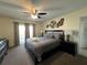 Comfortable main bedroom with furniture, ceiling fan, and access to the outdoors at 2494 Sweetwater Club Cir # 55, Kissimmee, FL 34746