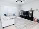 Bright living room with contemporary furnishings, neutral tones, and large window for natural light at 2663 Sand Hill Point Cir, Davenport, FL 33837
