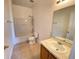 Standard bathroom featuring a shower-tub combo, toilet, and vanity with a mirror at 296 Sand Ridge Dr, Davenport, FL 33896