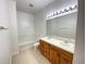 Well lit bathroom featuring double sink vanity, soaking tub, and neutral tiling at 296 Sand Ridge Dr, Davenport, FL 33896