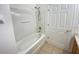 Clean bathroom with white tub-shower combo and a white door at 296 Sand Ridge Dr, Davenport, FL 33896