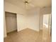 Bedroom with tile flooring, a ceiling fan, and a closet with sliding doors at 296 Sand Ridge Dr, Davenport, FL 33896