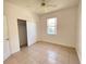 Cozy bedroom with tile flooring, a ceiling fan, closet with sliding doors, and a window at 296 Sand Ridge Dr, Davenport, FL 33896