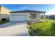 Charming single-story home with a well-maintained lawn, attached garage, and freshly painted driveway at 296 Sand Ridge Dr, Davenport, FL 33896