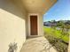 Inviting front entrance featuring a classic brown door and a well-kept porch, enhancing curb appeal at 296 Sand Ridge Dr, Davenport, FL 33896