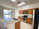 Bright kitchen features stainless steel appliances and a breakfast bar overlooking the outdoor view at 296 Sand Ridge Dr, Davenport, FL 33896