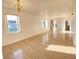 Spacious living room featuring tile floors, classic chandelier, and multiple windows, creating a bright atmosphere at 296 Sand Ridge Dr, Davenport, FL 33896