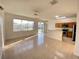 Open-concept living room with kitchen view, tile floors, and lots of light, perfect for modern living at 296 Sand Ridge Dr, Davenport, FL 33896