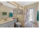 Bright bathroom featuring a shower, toilet, sink, and door to outside at 311 N Hampton Dr, Davenport, FL 33897