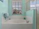 Close up of the soaking tub and the window in the bright and airy bathroom at 311 N Hampton Dr, Davenport, FL 33897