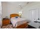 A bright bedroom featuring a large bed, a ceiling fan, and natural light at 311 N Hampton Dr, Davenport, FL 33897