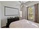 Bedroom with a ceiling fan, closet, and a large window with bright natural light at 311 N Hampton Dr, Davenport, FL 33897