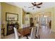Dining area with tile flooring, a modern ceiling fan, and an open view to the front foyer at 311 N Hampton Dr, Davenport, FL 33897