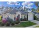 Charming single Gathering home with a well maintained lawn and beautiful, colorful landscaping at 311 N Hampton Dr, Davenport, FL 33897