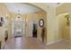 Bright foyer featuring tile flooring, a decorative light fixture, and a view into other rooms at 311 N Hampton Dr, Davenport, FL 33897