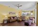 Living room with wood flooring, comfortable seating, and open access to the kitchen at 311 N Hampton Dr, Davenport, FL 33897