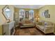 Comfortable living room with a cozy seating area, a decorative fireplace, and natural light at 311 N Hampton Dr, Davenport, FL 33897