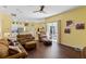 Spacious living room with wood flooring, sliding glass doors, and open layout to the kitchen at 311 N Hampton Dr, Davenport, FL 33897