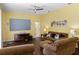 Comfortable living room with dark wood floors, a large screen, and ample seating at 311 N Hampton Dr, Davenport, FL 33897