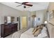 Main bedroom showcasing a dresser, ceiling fan, and en-suite bathroom access at 311 N Hampton Dr, Davenport, FL 33897