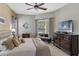 Main bedroom featuring a bed with decorative pillows, dresser, and sliding glass doors to the lanai and pool at 311 N Hampton Dr, Davenport, FL 33897