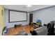 Enjoy this media room featuring projector screen, laminate flooring, and theater seating at 311 N Hampton Dr, Davenport, FL 33897