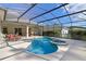 Pool and spa with covered patio, outdoor seating, and screened enclosure enhances outdoor living at 311 N Hampton Dr, Davenport, FL 33897