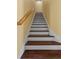 Traditional staircase with wooden railing and hardwood steps offers access to upper floors at 311 N Hampton Dr, Davenport, FL 33897