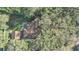 Aerial view of home showcasing the backyard, patio, and surrounding trees at 3165 Maple Run, Kissimmee, FL 34744