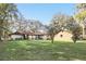 Expansive backyard featuring lush green grass and mature trees at 3165 Maple Run, Kissimmee, FL 34744