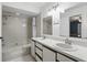 Bright bathroom featuring a double sink vanity, tiled shower-tub, and neutral color scheme at 3165 Maple Run, Kissimmee, FL 34744