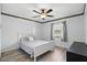 Bedroom with light colored floor and ceiling trim, a window overlooking outside, and a ceiling fan at 3165 Maple Run, Kissimmee, FL 34744
