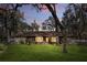 Charming ranch-style home with stone accents, a well-manicured lawn, and mature trees offering shade at 3165 Maple Run, Kissimmee, FL 34744