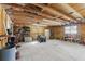 Large garage with exposed wood beam ceiling, tools, and a lawnmower at 3165 Maple Run, Kissimmee, FL 34744