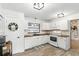 Well-lit kitchen with white cabinets, wood countertops, and modern fixtures at 3165 Maple Run, Kissimmee, FL 34744