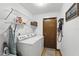 Functional laundry room with washer, dryer, storage shelves, and ironing board at 3165 Maple Run, Kissimmee, FL 34744