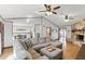 Spacious living room featuring a stone fireplace, wood floors, and an open layout to the dining area at 3165 Maple Run, Kissimmee, FL 34744