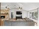 Bright living room featuring a stone fireplace, wood floors, and a large TV at 3165 Maple Run, Kissimmee, FL 34744