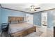 Main bedroom featuring an ensuite bathroom and a rustic-style wood bed frame at 3165 Maple Run, Kissimmee, FL 34744