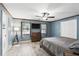 Bedroom with blue walls, hardwood floors, and a large window for natural light at 3165 Maple Run, Kissimmee, FL 34744