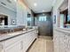 This stylish bathroom features a glass-enclosed shower, double vanity, and contemporary fixtures at 3240 Songbird Cir, Harmony, FL 34773