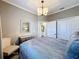 Bedroom with a light-colored chair, a chest of drawers, and light-colored walls at 3240 Songbird Cir, Harmony, FL 34773