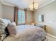 Serene bedroom featuring neutral tones, a large window for natural light, and comfortable bedding at 3240 Songbird Cir, Harmony, FL 34773
