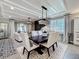 Elegant dining area with a dark wood table, upholstered chairs, and stylish chandelier at 3240 Songbird Cir, Harmony, FL 34773