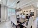 Elegant dining room with a crystal chandelier, dining table, and comfortable seating at 3240 Songbird Cir, Harmony, FL 34773