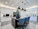 Spacious kitchen with island, white cabinets, stainless steel appliances, and bar stool seating at 3240 Songbird Cir, Harmony, FL 34773